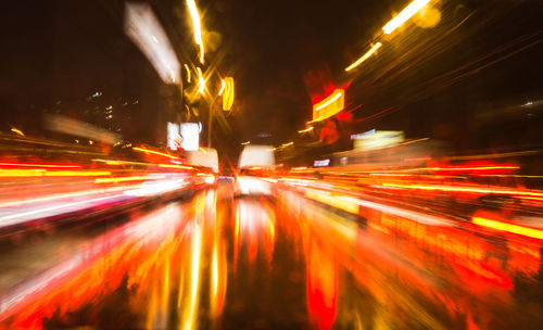 Light trails on road in city at night