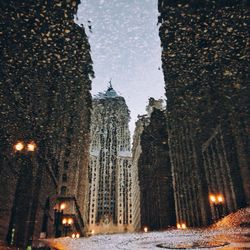 Road passing through illuminated city at night