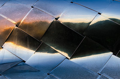 Low angle view of wet umbrella against sky