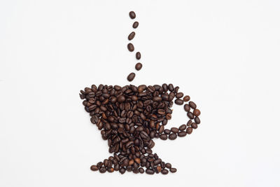 High angle view of coffee beans against white background