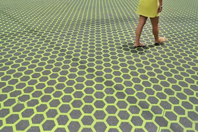 Low section of woman standing on tiled floor
