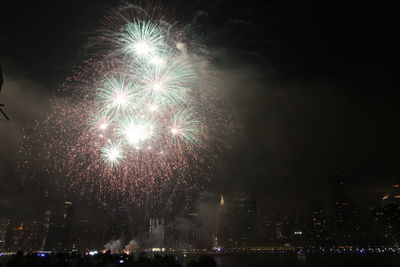 Low angle view of firework display at night