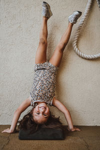 Girl upside down doing headstand 