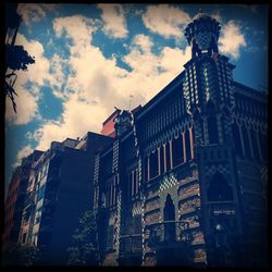 Low angle view of building against cloudy sky