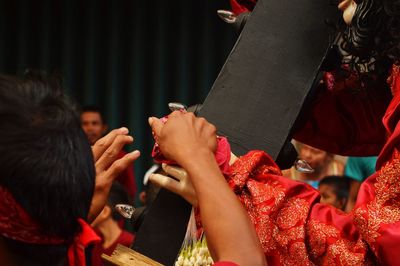 Rear view of people holding cross