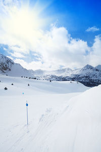 Scenic view of snow covered mountains against sky