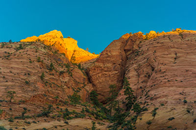 Scenic view of mountains against clear blue sky