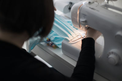 Woman making facemasks for coronavirus pandemic