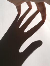 Low section of child shadow on hand