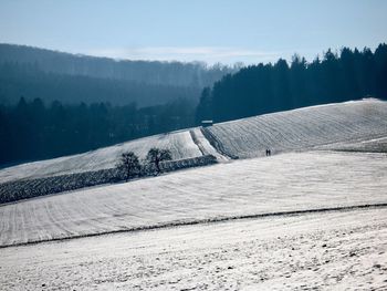 Scenic view of landscape against sky during winter