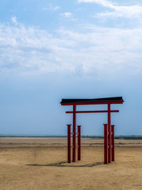 Lifeguard hut on beach against sky