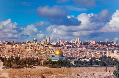 Panoramic view of buildings in city against sky