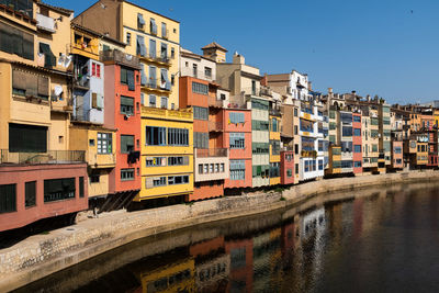 Gerona, spain, multicolored houses in the old town with their charming reflections in the river. 