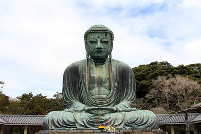 Statue of buddha against sky