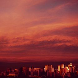 View of cityscape against cloudy sky during sunset