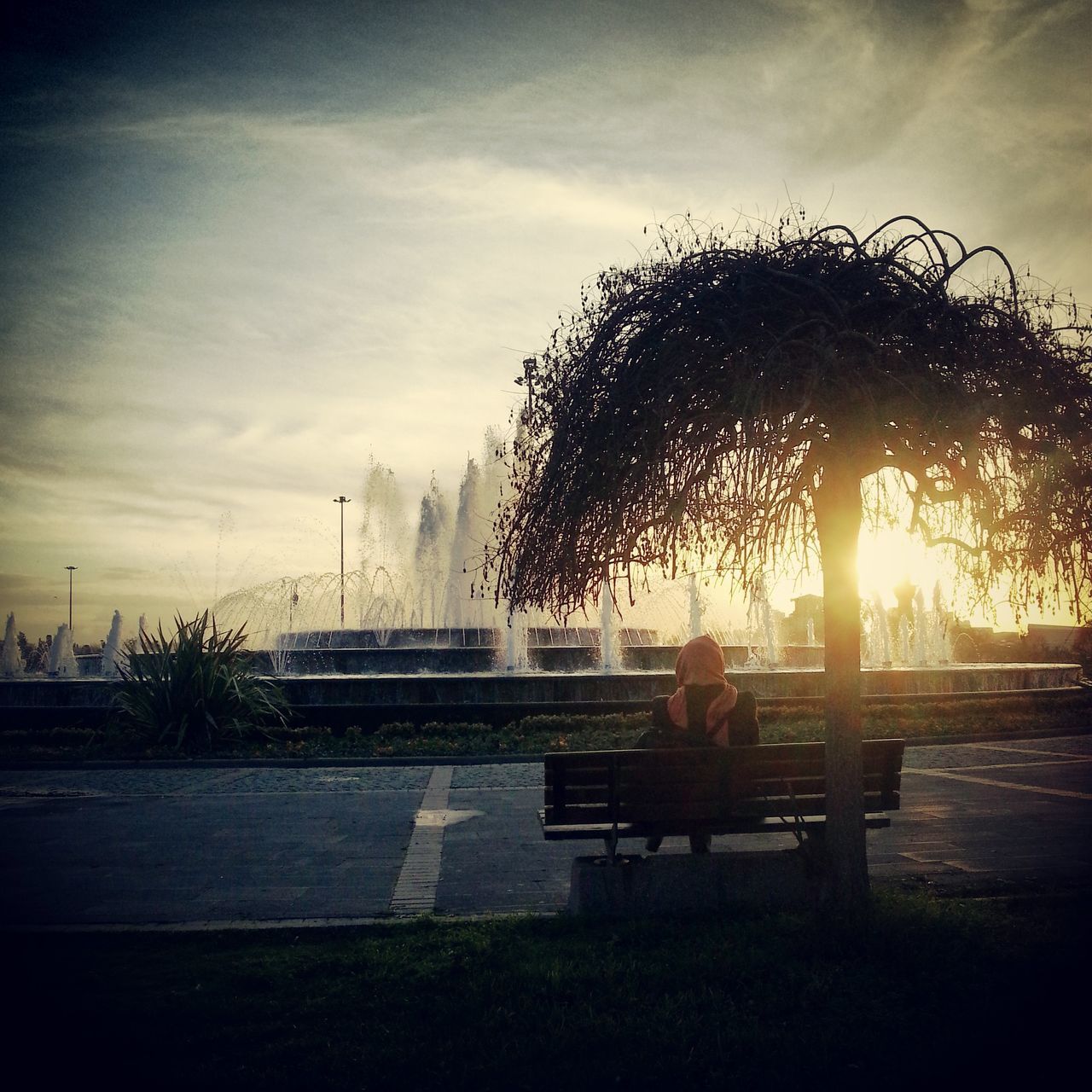 sky, sun, lifestyles, leisure activity, sunlight, sitting, sunset, sunbeam, tree, silhouette, bench, lens flare, men, childhood, cloud - sky, field, nature, person