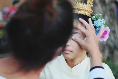 Beautician applying make-up on young woman