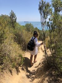 Rear view of man walking on shore