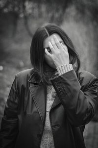 Portrait of woman standing by house