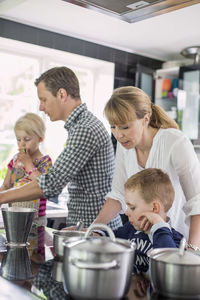 Family preparing food in kitchen