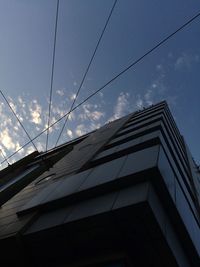 Low angle view of building against cloudy sky