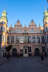Low angle view of buildings against blue sky