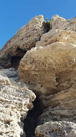 Rock formations against clear blue sky