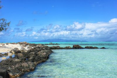 Scenic view of sea against cloudy sky