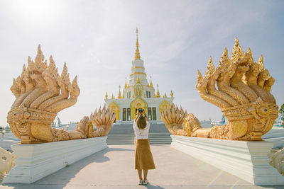 Statue of temple against building