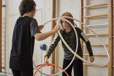 Children playing with hula hoops in school gym