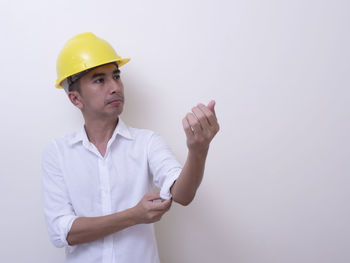 Midsection of man working against white background