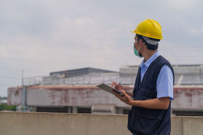 Man working against sky