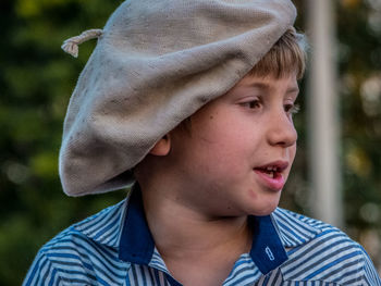 Close-up of thoughtful boy wearing flat cap