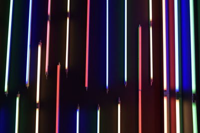 Full frame shot of illuminated fluorescent lights on wall