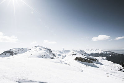 Scenic view of snow covered mountains against sky