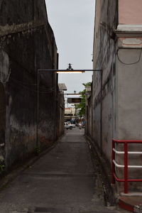 Empty alley amidst buildings in city