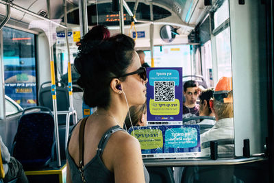 Rear view of woman sitting in train