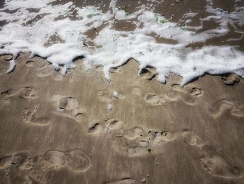 High angle view of wet sand on beach