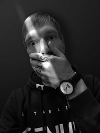 Portrait of boy against black background