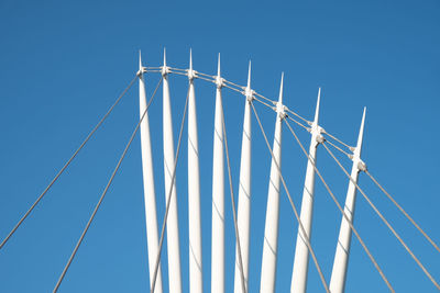 Low angle view of metallic structure against clear blue sky