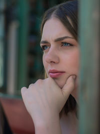 Close-up portrait of young woman looking away