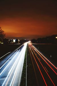 High angle view of light trails on highway at night