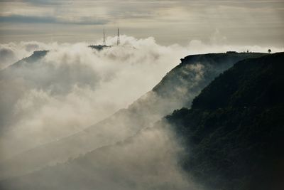 Scenic view of mountains against cloudy sky