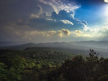 Scenic view of mountains against cloudy sky