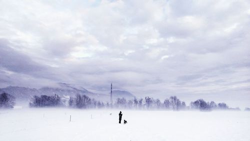 Scenic view of snow covered field against sky