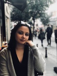 Portrait of beautiful woman standing on street in city