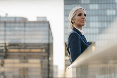 Businesswoman standing on bridge