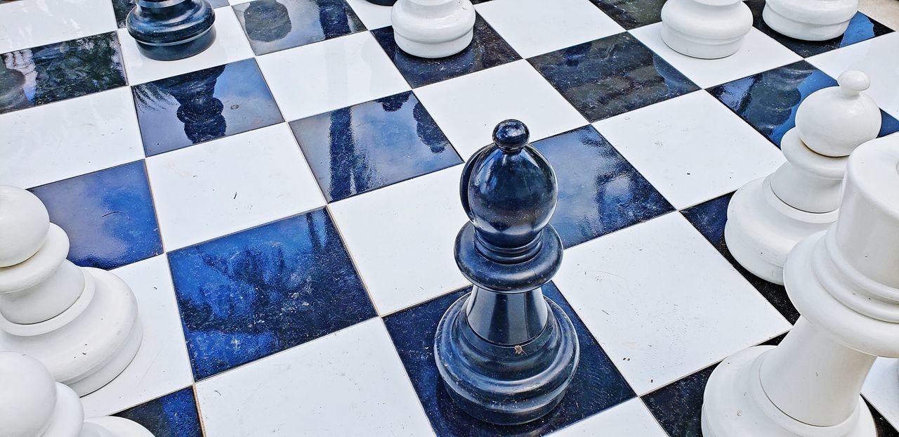 HIGH ANGLE VIEW OF CHESS PIECES ON THE FLOOR