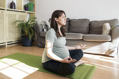 Young woman sitting on floor