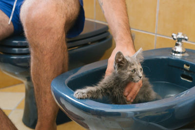 Low section of man washing hands